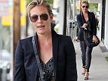 New mother Cat Deeley looks trim in colourful snakeskin jumpsuit