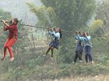 Nepalese schoolchildren have to operate a flimsy cable 50ft above a river to get to class