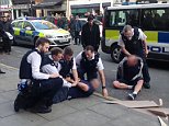 Moment two men are arrested in London's Hatton Garden diamond district after 'one made threats with a knife and another assaulted a police officer' 