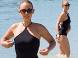 Louise Pillidge wears a black bikini as she hits Waikiki Beach in Hawaii