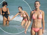 Joanna Krupa gets cheeky with a pretty pal in bikinis