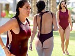 Danielle Lloyd showcases her toned curves in a red-hot swimsuit as she soaks up some winter sun in Dubai