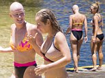Jessica Marais's girlfriend Shannon Dooley takes off her wig during bikini-clad outing with actress on the beach after pair deny they are in a relationship