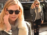 Karlie Kloss bares a bit of skin in tattered jeans despite blustery sweater weather in New York City