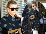 Sofia Richie covers up in large shades and baggy navy coat