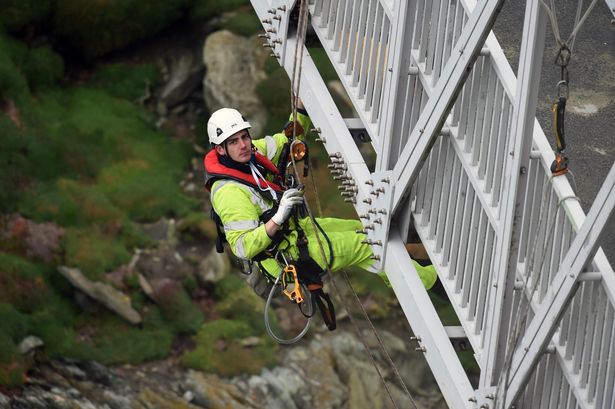 Watch daredevil engineers test Anglesey lighthouse footbridge