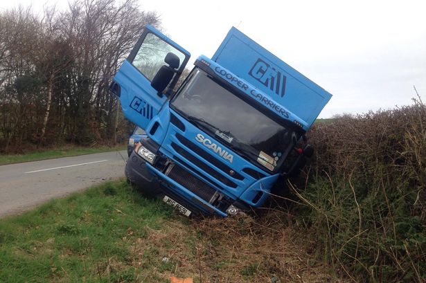 Truck tips into ditch on side of Conwy road