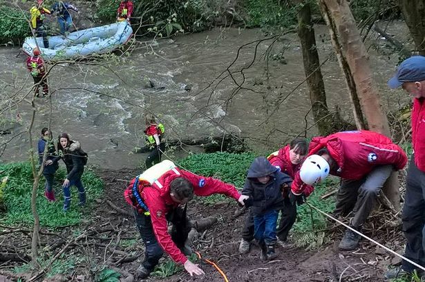Family trapped between swollen stream and steep slope rescued