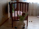 Russian baby moves a heavy cot on his own