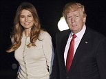 Trump holds hands with Melania on return to the US