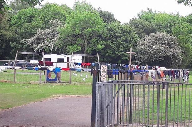 Travellers turn kids' playground into mobile launderette as they set up camp in park