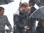 Prince Harry gets soaked in Sydney while greeting fans
