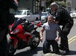 Shocking moment motorcyclist rides through protest group