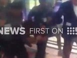 Six guards carry drunken man off Qantas as crowds cheer