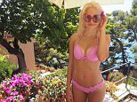 Pixie Lott gives a flash of her ample cleavage in Capri