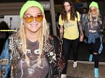 Kesha lands in LA with boyfriend and No. 1 Billboard album