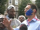 Notting Hill carnival goers cover a reporter in paint