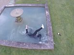 Moment girl falls into a fountain while posing for a drone