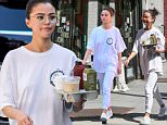 Selena Gomez sports geek chic glasses and an oversized tee