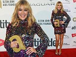 Kylie Minogue parades her legs in a sequin minidress