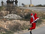 'Santa Claus' protester throws rocks at Israeli soldiers
