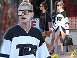 Hailey Baldwin flaunts her tanned legs in tiny shorts