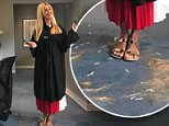Roxy Jacenko poses in a pile of hair at work in Sydney