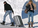 Sophie Monk watches Stu Laundy move his luggage