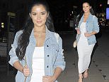 Demi Rose Mawby accentuates her figure in a plunging maxi