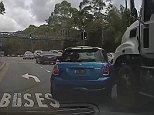 Mini driver gets dragged along by truck in Sydney