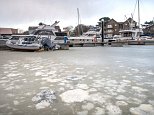 Boats are stuck fast in frozen sea at Isle of Wight harbour