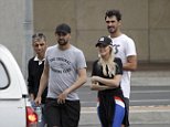 Nathan Lyon walks with Emma McCarthy and Australian cricket team
