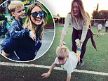 Hilary Duff is all smiles as she teaches son Luca, six, the wheelbarrow as they bond at school event
