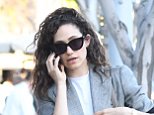 Emmy Rossum rocks curly locks and looks effortlessly chic in a oversized blazer and jeans