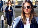 Jessica Alba wows in blue velvet ensemble and dazzling silver sneakers as she jets into NYC in style