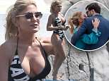 Hofit Golan in plunging black swimsuit as she kisses 'beau' in Cannes