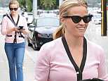 Reese Witherspoon steps out in a blush sweater and smart pumps