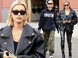 Hailey Baldwin goes from baggy cargo bottoms to skintight leather as she shows off stunning stems