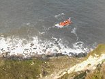 Moment family of four including two schoolboys are rescued after being cut off by a rising tide