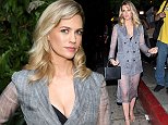 January Jones flaunts her cleavage in a quirky blazer with sheer skirt at Max Mara WIF bash