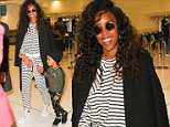 Makeup free Kelly Rowland cuts a casual figure in a striped tracksuit as she jets out of Sydney
