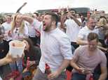 Over-excited England fans clamber over moving cars as they pour out of pubs
