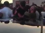 Shocking moment a father is beaten up outside a burger restaurant