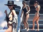 Kourtney Kardashian flashes some sideboob in low-cut black swimsuit