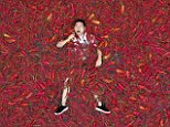 Chinese chilli-eating contest gets competitors sweating as they scoff them while bathing in peppers