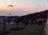 Trump is quickly ushered inside Turnberry resort as Greenpeace paraglider buzzes overhead