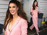 Delta Goodrem dazzles in a plunging power suit as she leaves the launch for new fragrance Dream 