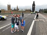 Tourists pose for Westminster Bridge selfies after terror attack