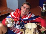 Antoine Griezmann enjoys a burger and a beer after Super Cup victory