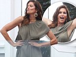 Cindy Crawford giddily poses up a storm in sophisticated chiffon dress at Malibu beach house